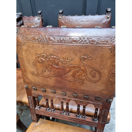 1283 - A set of four late 19th century carved walnut and embossed tanned leather dining chairs, with decora... 