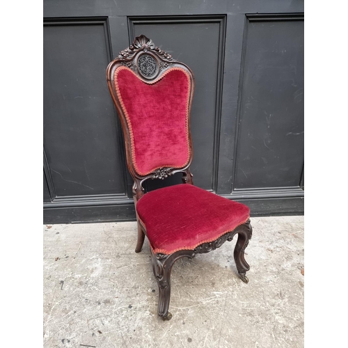 1285 - A Victorian carved walnut and red draylon nursing chair.