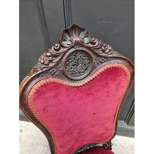 1285 - A Victorian carved walnut and red draylon nursing chair.