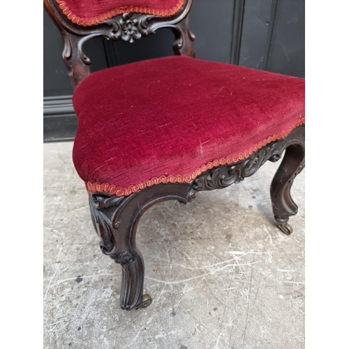 1285 - A Victorian carved walnut and red draylon nursing chair.