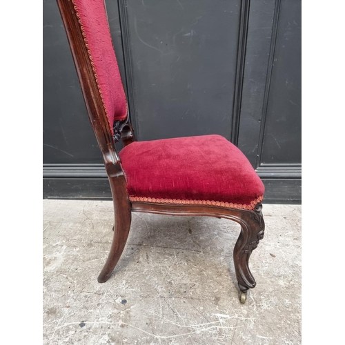 1285 - A Victorian carved walnut and red draylon nursing chair.