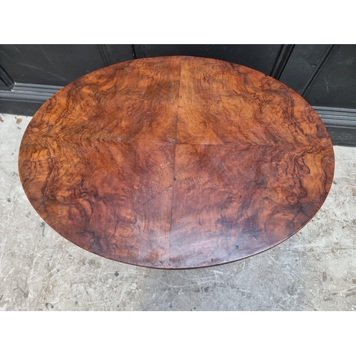 1287 - A late Victorian figured walnut oval folding table, labelled, 68.5cm wide.