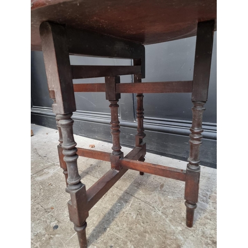 1287 - A late Victorian figured walnut oval folding table, labelled, 68.5cm wide.