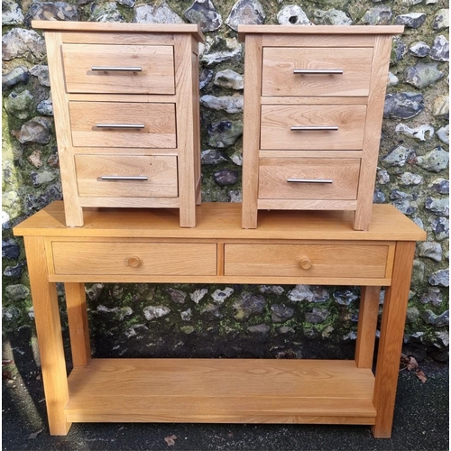 1293 - A contemporary pale oak two drawer side table, 122cm wide; together with a similar pair of bedside c... 