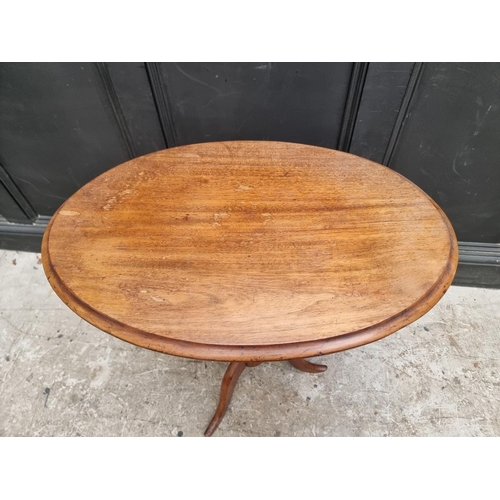 1319 - A 19th century mahogany oval tilt-top tripod table, 68.5cm wide.