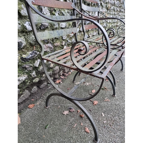 1320 - A pair of green painted steel garden chairs.