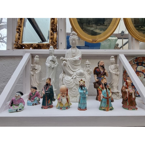 1356 - A collection of Chinese blanc de chine and famille rose figures, largest 45cm high. (12)... 