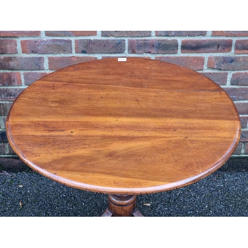 1215 - A Victorian mahogany and ash circular tilt top tripod table, 75cm diameter.