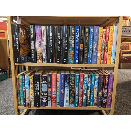 351 - PRATCHETT (Terry): a collection of 43 volumes by Pratchett over 2 shelves, some first editions, gene... 