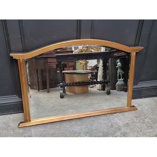 1323 - A reproduction gilt framed overmantel mirror, 77 x 124cm.