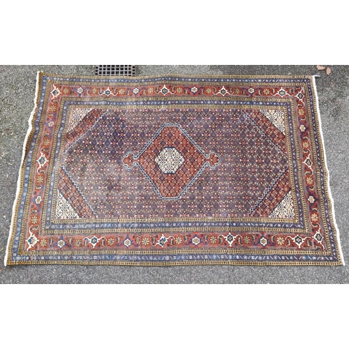 1753 - A large North West Persian rug, having central diamond medallion, with floral borders, 290 x 196cm.... 