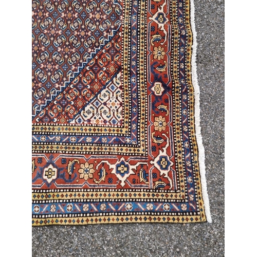 1753 - A large North West Persian rug, having central diamond medallion, with floral borders, 290 x 196cm.... 