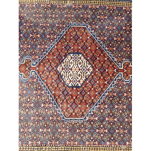 1753 - A large North West Persian rug, having central diamond medallion, with floral borders, 290 x 196cm.... 