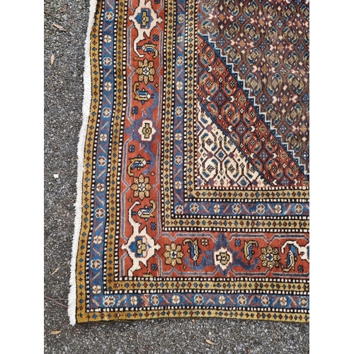 1753 - A large North West Persian rug, having central diamond medallion, with floral borders, 290 x 196cm.... 