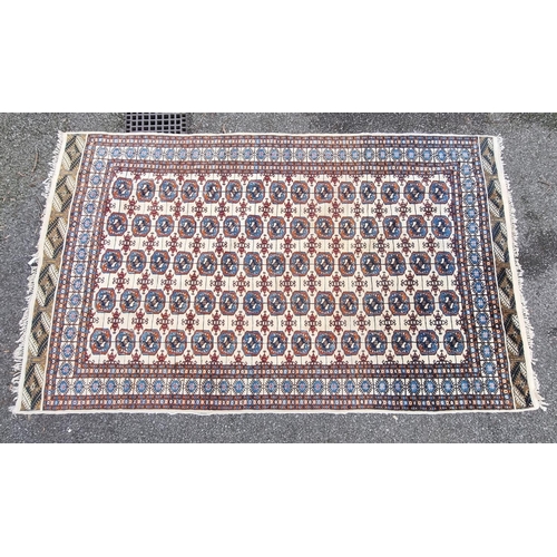 1756 - A large Bokhara rug, having repeated decoration to central field, 313 x 119cm.