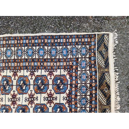 1756 - A large Bokhara rug, having repeated decoration to central field, 313 x 119cm.