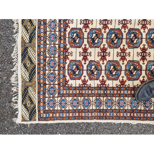 1756 - A large Bokhara rug, having repeated decoration to central field, 313 x 119cm.