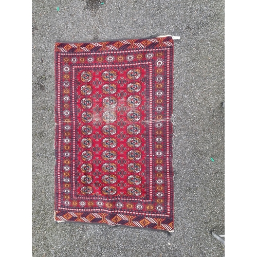 1757 - A small Bokhara rug, having repeated decoration, on red ground, 198 x 124cm.