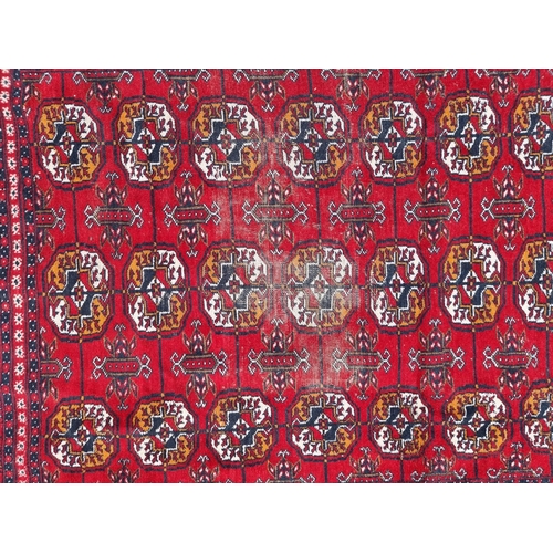 1757 - A small Bokhara rug, having repeated decoration, on red ground, 198 x 124cm.