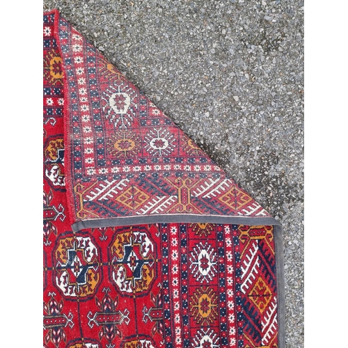 1757 - A small Bokhara rug, having repeated decoration, on red ground, 198 x 124cm.