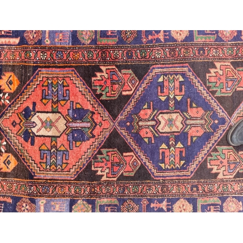 1758 - A Tribal rug, having three central medallions, borders decorated with animals, 238 x 126cm.... 