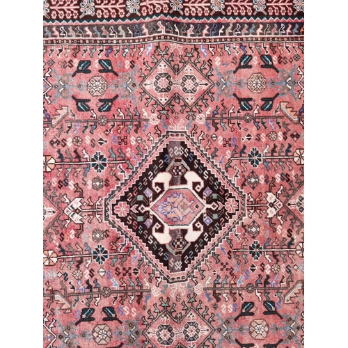 1765 - A large Persian rug, with central diamond medallion, with floral decoration, 264 x 161cm.... 