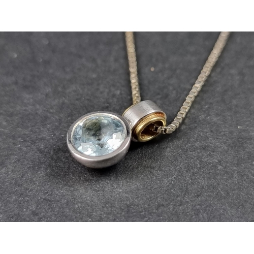 1005 - An 18ct white and yellow gold blue topaz pendant, 16mm high, on an 18ct white gold and unmarked meta... 