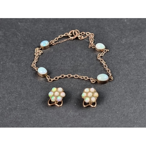 1006 - A yellow metal bracelet, set four cabochon opals, approx. 18cm long; together with a pair of yellow ... 