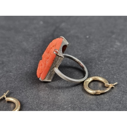 1017 - A coral ring, stamped 18ct, size M 1/2; together with a pair of hoop earrings, stamped 375. (3)... 