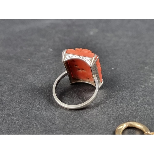 1017 - A coral ring, stamped 18ct, size M 1/2; together with a pair of hoop earrings, stamped 375. (3)... 