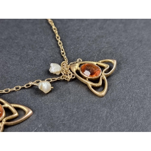 1021 - An Art Nouveau yellow metal necklace, set five citrines interspersed with six natural baroque pearls... 