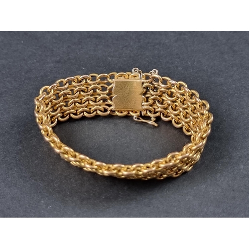 1033 - A yellow metal multi-link mesh bracelet, approx. 15cm long x 1.8cm wide.