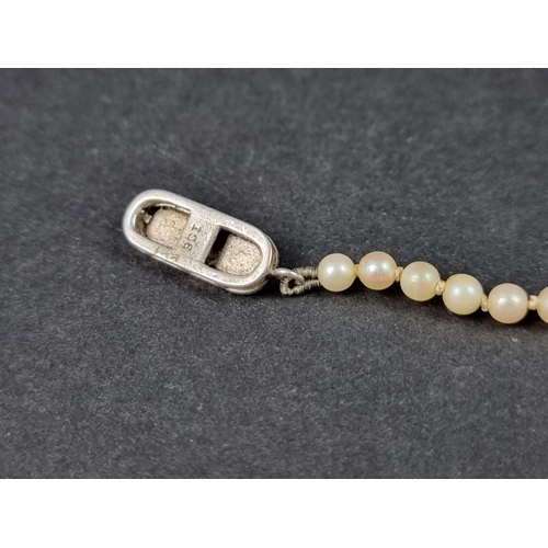 1053 - A graduated pearl necklace, the clasp stamped '9ct', 53cm long; together with a stick pin, having pe... 