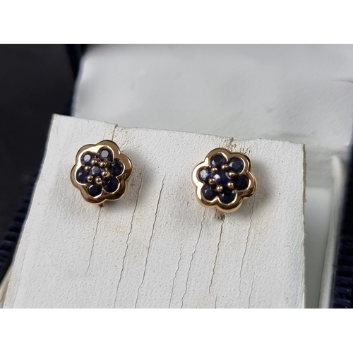 1060 - A pair of 9ct gold sapphire cluster ear studs; together with another pair of 9ct gold ear studs, set... 