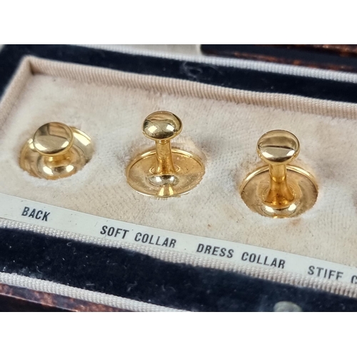 1061 - A cased set of six yellow metal studs, each stamped 9ct.