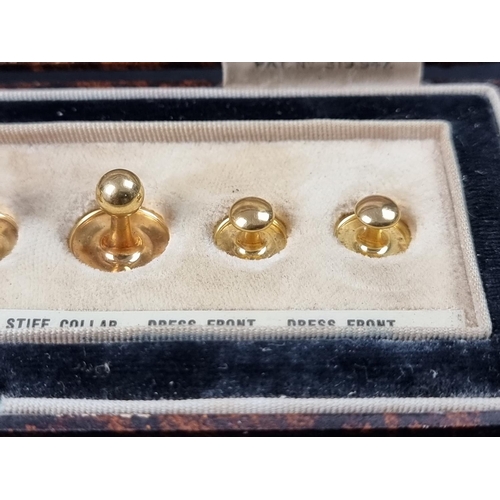 1061 - A cased set of six yellow metal studs, each stamped 9ct.