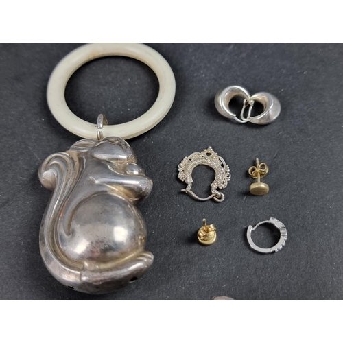 1071 - A quantity of silver and white metal jewellery; together with a child's silver novelty squirrel ratt... 