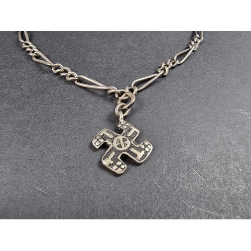 1074 - A silver watch chain, with attached metal swastika pendant, 44cm long, gross weight 27g.... 