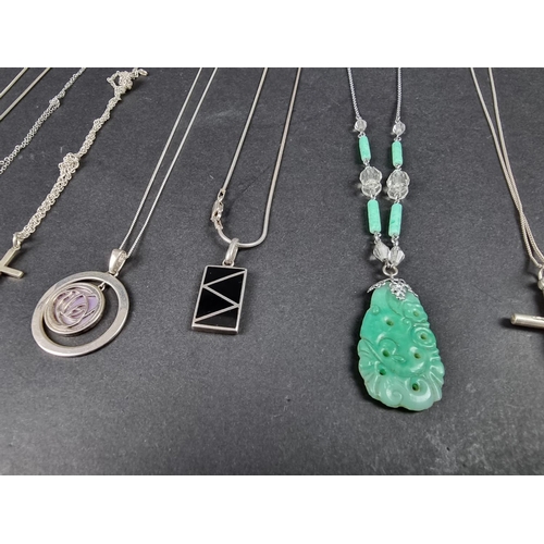 1076 - A quantity of white metal necklaces and pendants, stamped '925'; to include a carved jadeite pendant... 