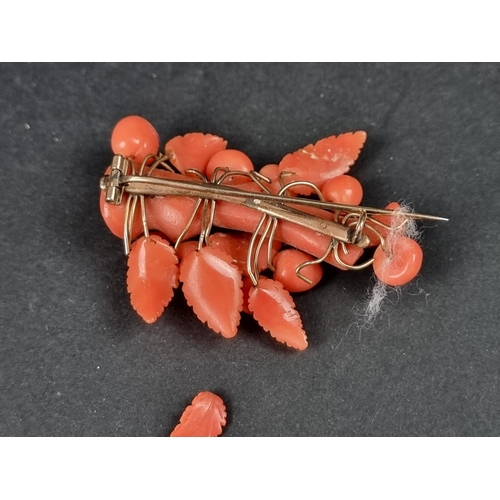 1093 - A Victorian yellow metal and carved coral floral brooch, 5.4cm.