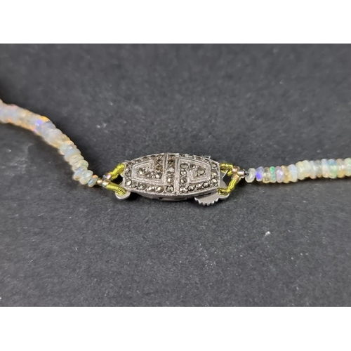 1097 - A graduated opal faceted bead necklace, with silver marcasite clasp, approx. 40cm long.... 