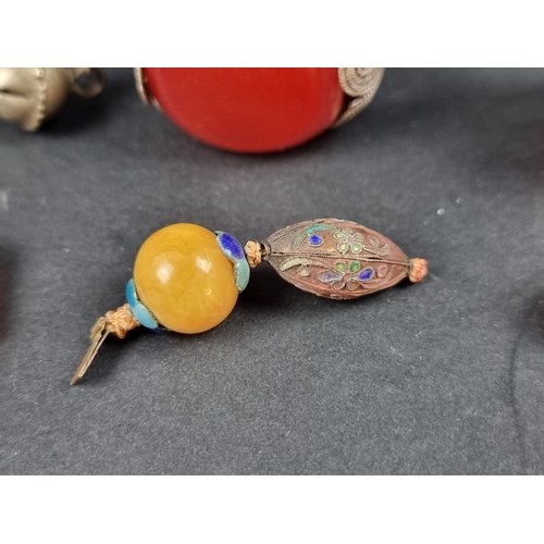 1102 - Two large Bakelite 'cherry amber' beads, one mounted as a pendant; and three other items. (5)... 