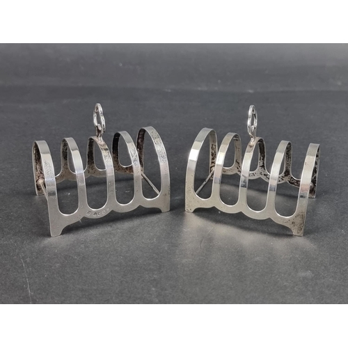 640 - A pair of silver four division toast racks, by Charles S Green & Co Ltd , 7.7cm long, 89g.... 