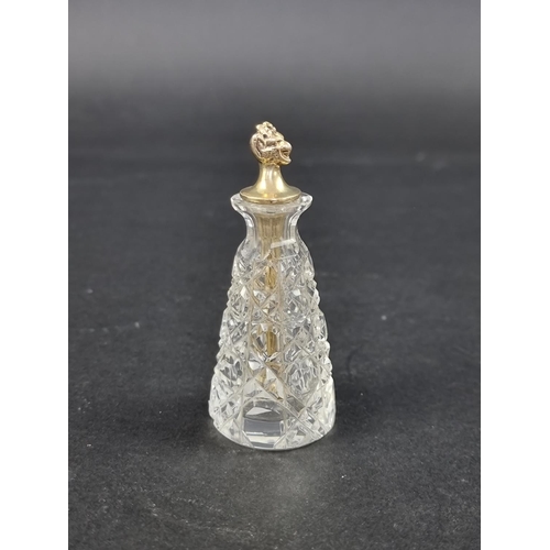 665 - A cut glass cayenne pepper bottle, with silver gilt devil's head stopper, by John Grinsell & Son... 