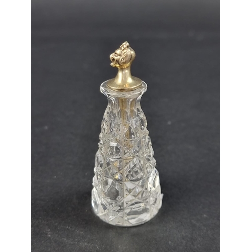 665 - A cut glass cayenne pepper bottle, with silver gilt devil's head stopper, by John Grinsell & Son... 