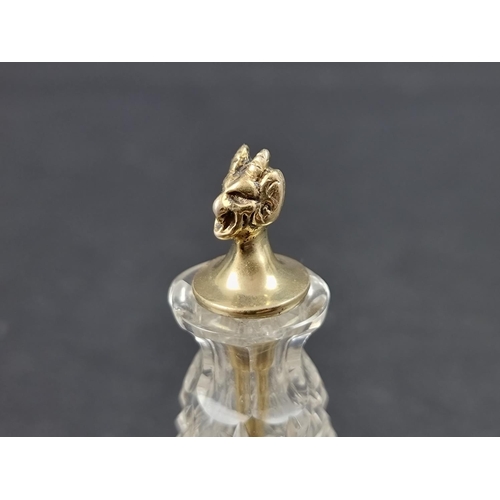 665 - A cut glass cayenne pepper bottle, with silver gilt devil's head stopper, by John Grinsell & Son... 