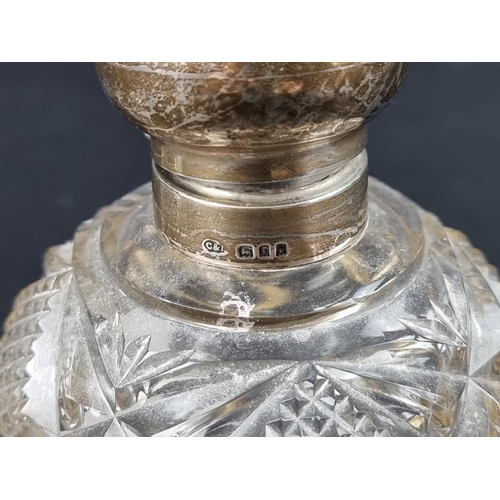 669 - Two silver lidded cut glass scent bottles, largest 11.5cm high.