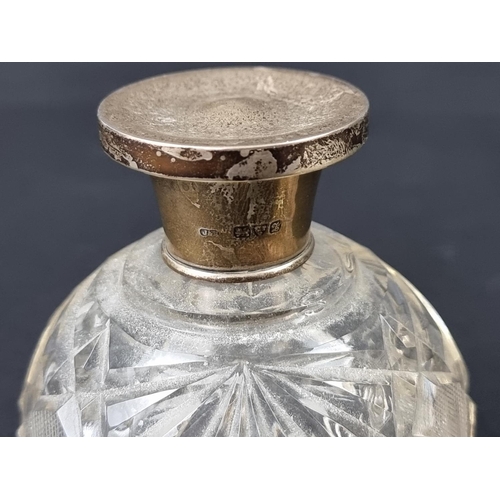 669 - Two silver lidded cut glass scent bottles, largest 11.5cm high.