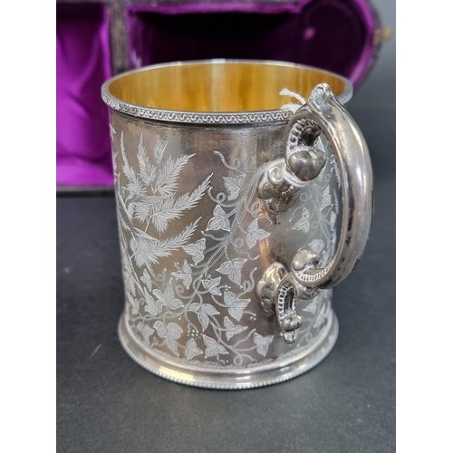 679 - A cased Victorian silver mug, having gilt interior, by Henry Holland, London 1876, 9cm high, 196g.... 