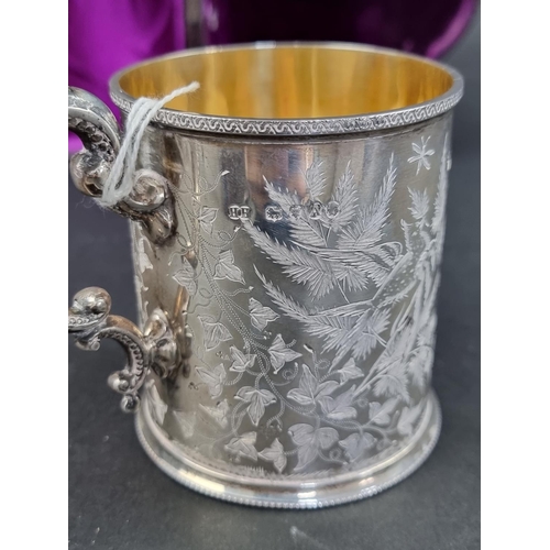 679 - A cased Victorian silver mug, having gilt interior, by Henry Holland, London 1876, 9cm high, 196g.... 